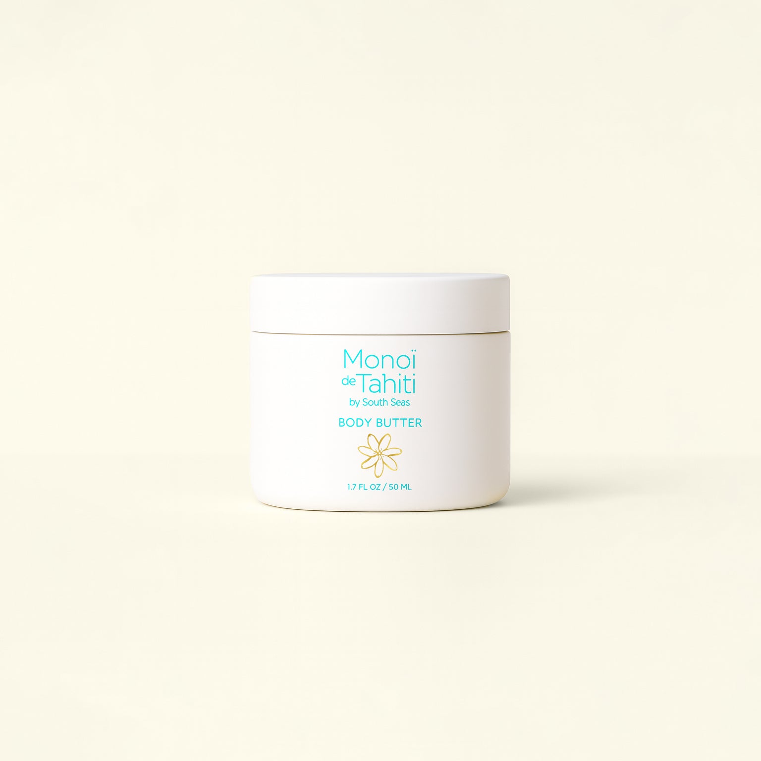 White jar of Monoi de Tahiti body butter on a light beige background