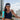 Bronzed woman holding a bottle of Tahitian Tan Extender 3.4 ounce from South Seas Skin Care