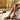 Alt text: Close-up of glowing, sun-kissed legs in cozy socks on an autumn porch