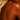Deep bronzed skin under warm studio lighting showing rich, even self-tan color